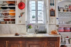 marble kitchen sink with a traditional wooden dish rack